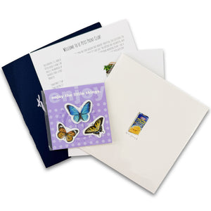 Lay flat image of Le Petit Print art subscription club showcasing all the elements of the subscription artwork. Includes a limited edition print, custom envelope, note from the author, a recipe related to the print, and custom tiny stickers!